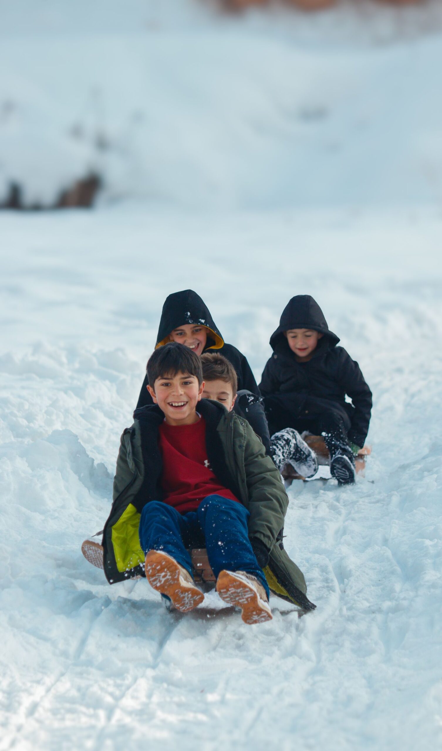 Group of children enjoying sledding on a snowy day
