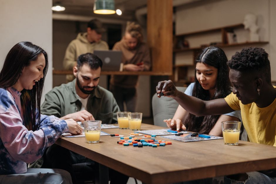 Friends playing a board game together at a table