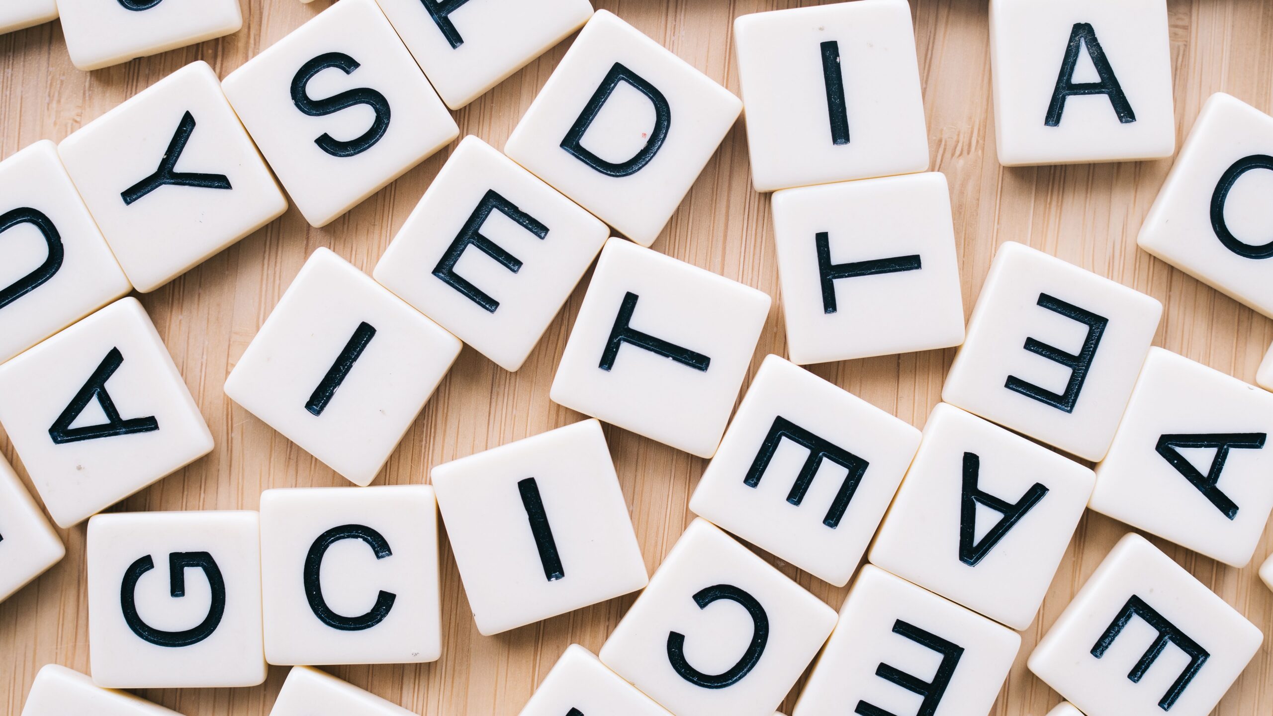 Scrabble tiles on a wooden surface