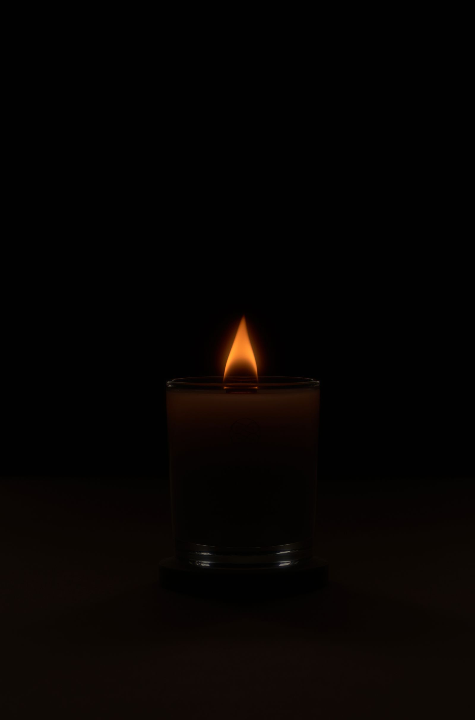 Candlelight glowing against dark background