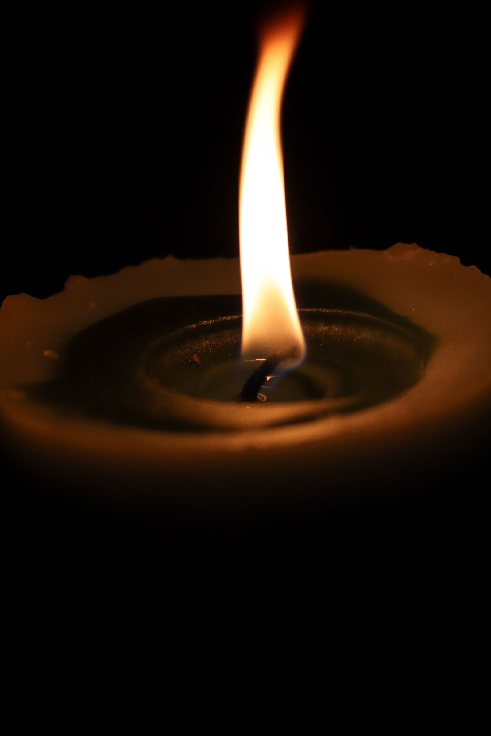 Lit candles in a dark interior