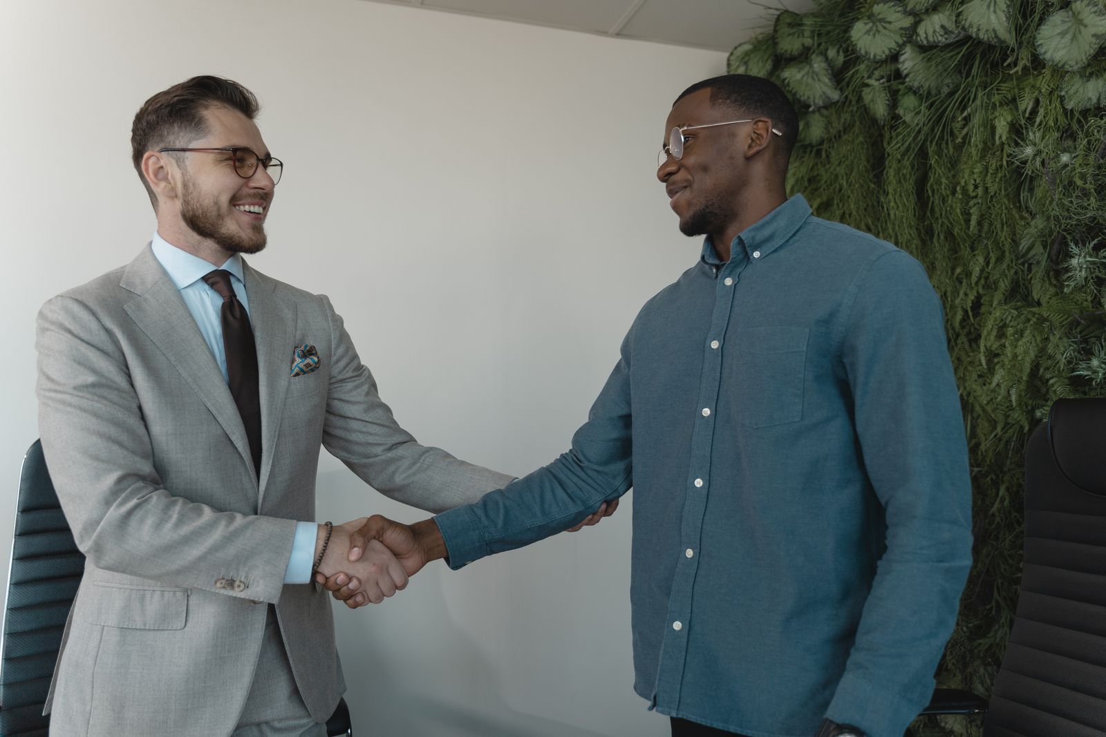 Partners shaking hands over a desk