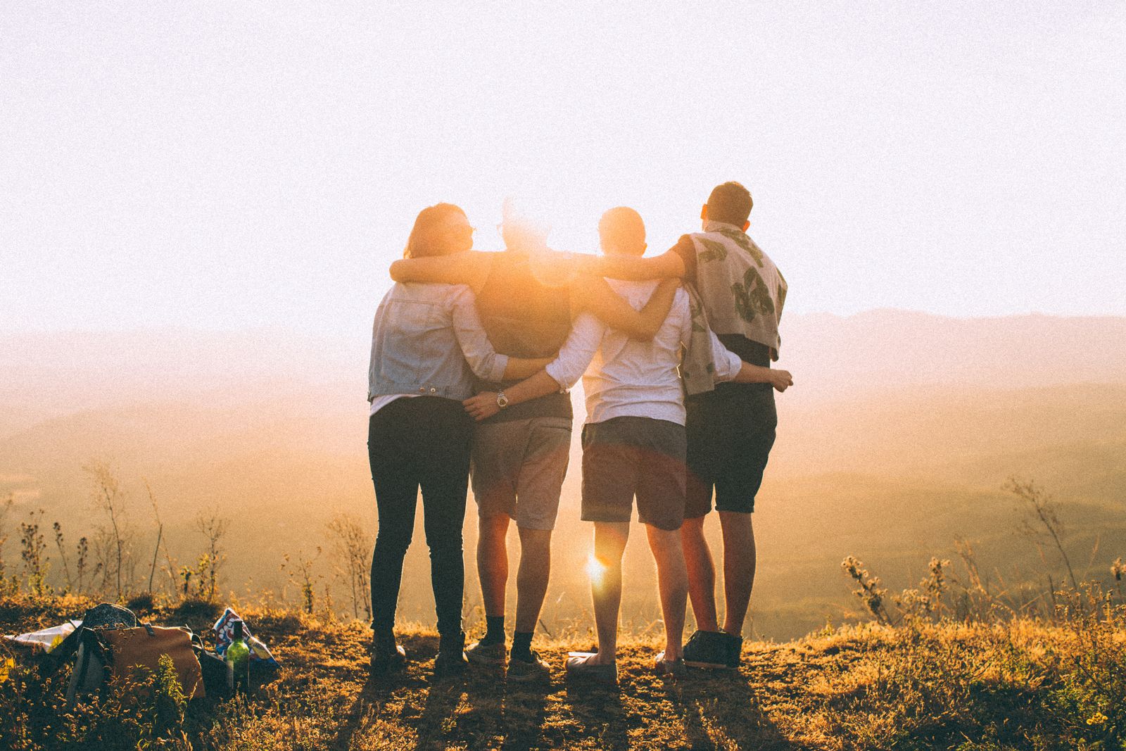 Group of friends silhouetted at sunset