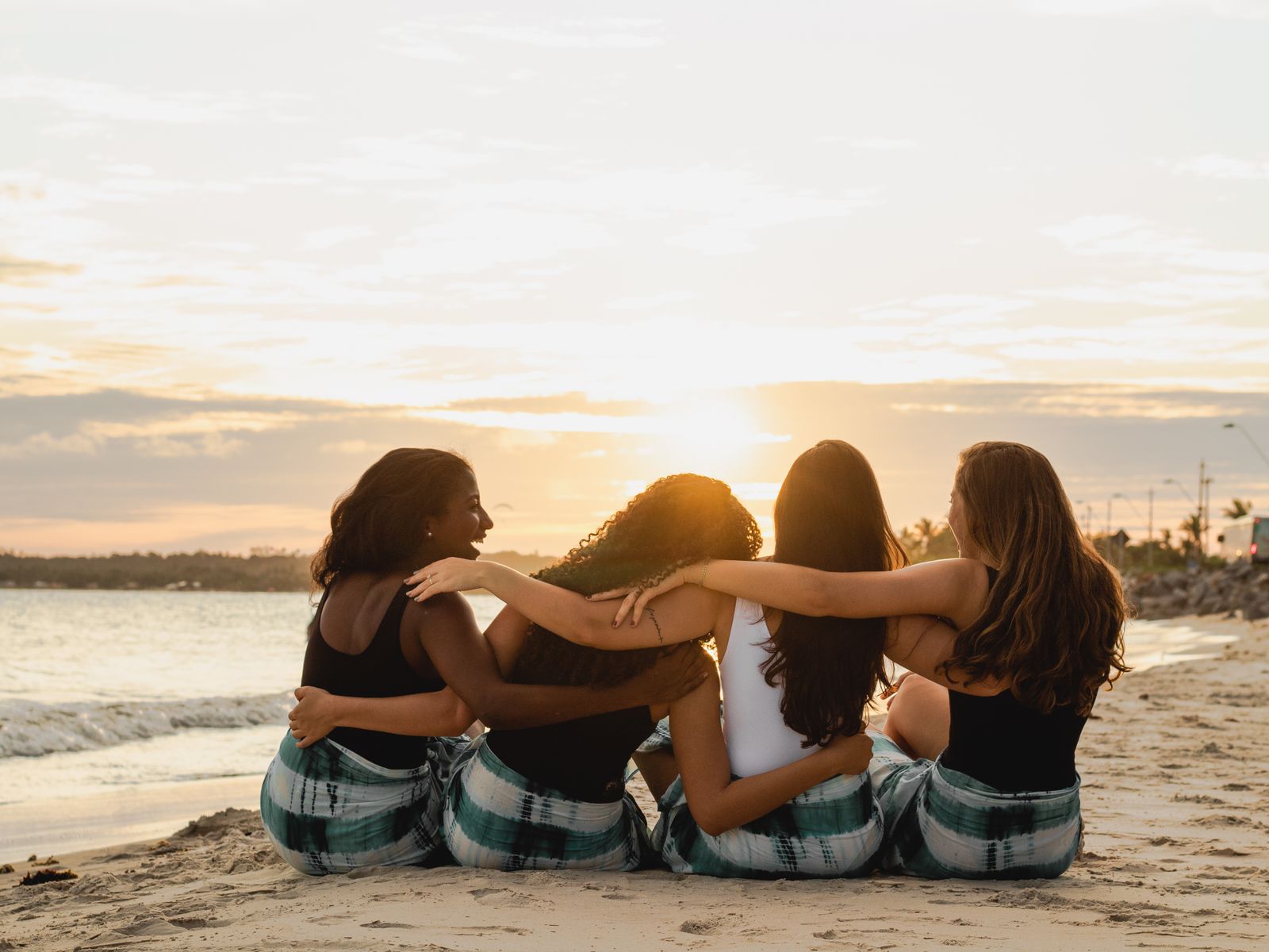 Friends enjoying sunset on a hill