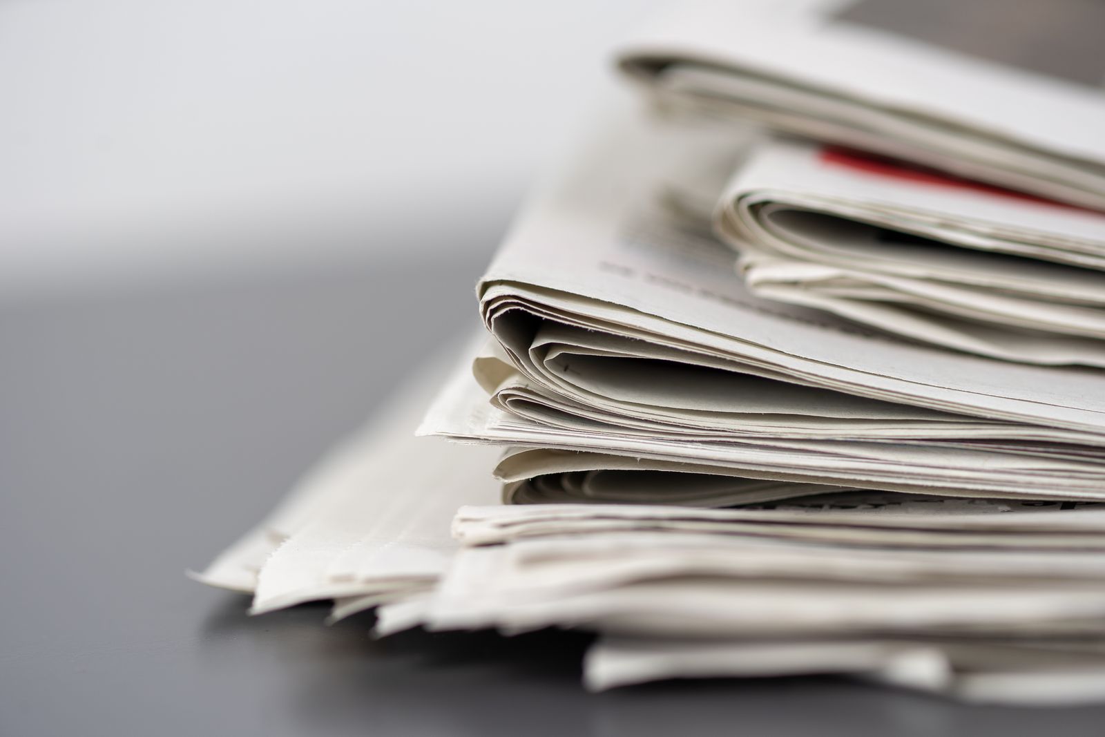 Pile of folded daily newspapers