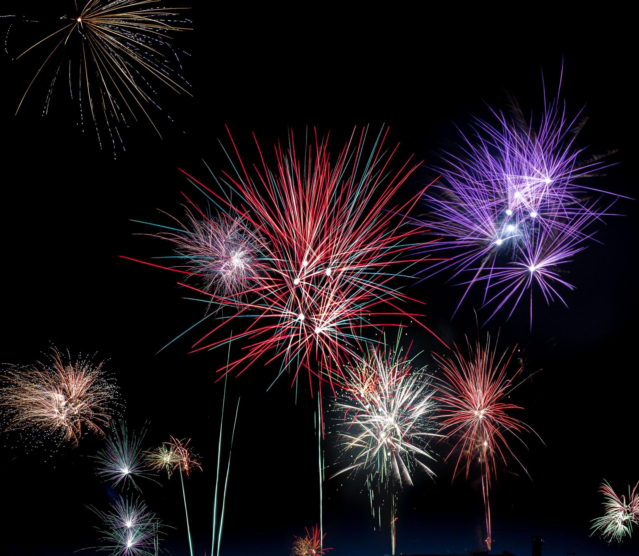 Bright fireworks exploding in the night sky