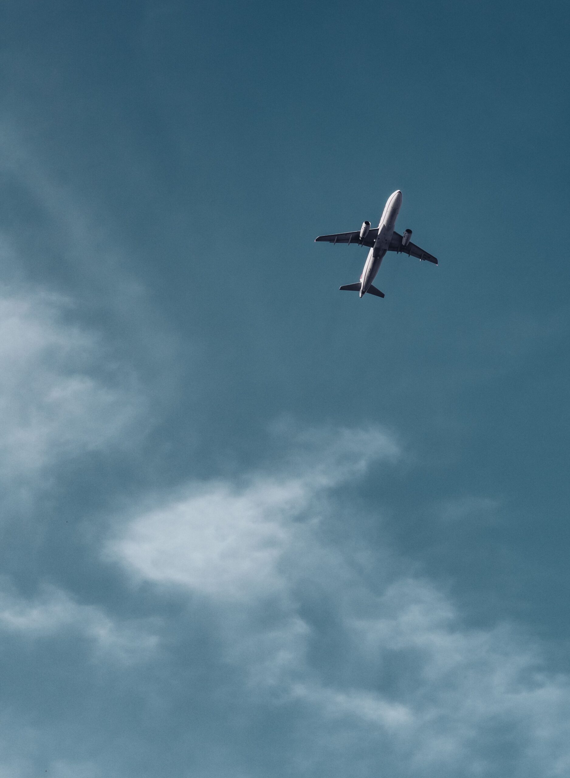 Airplane flying high across a blue sky