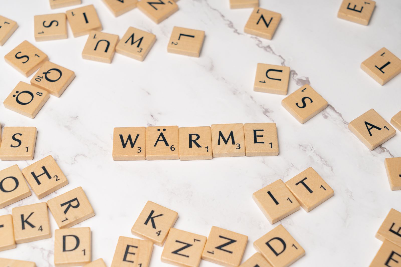 Scrabble tiles spelling a German word on marble