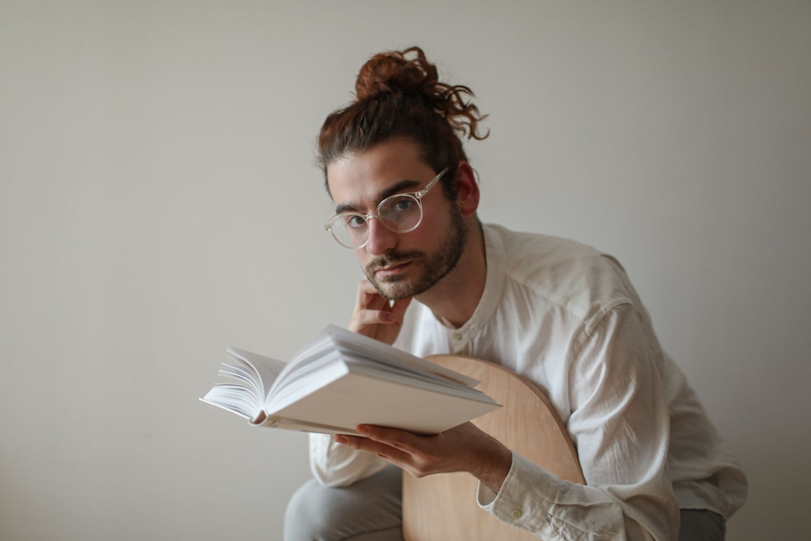 Student reading a book at a desk