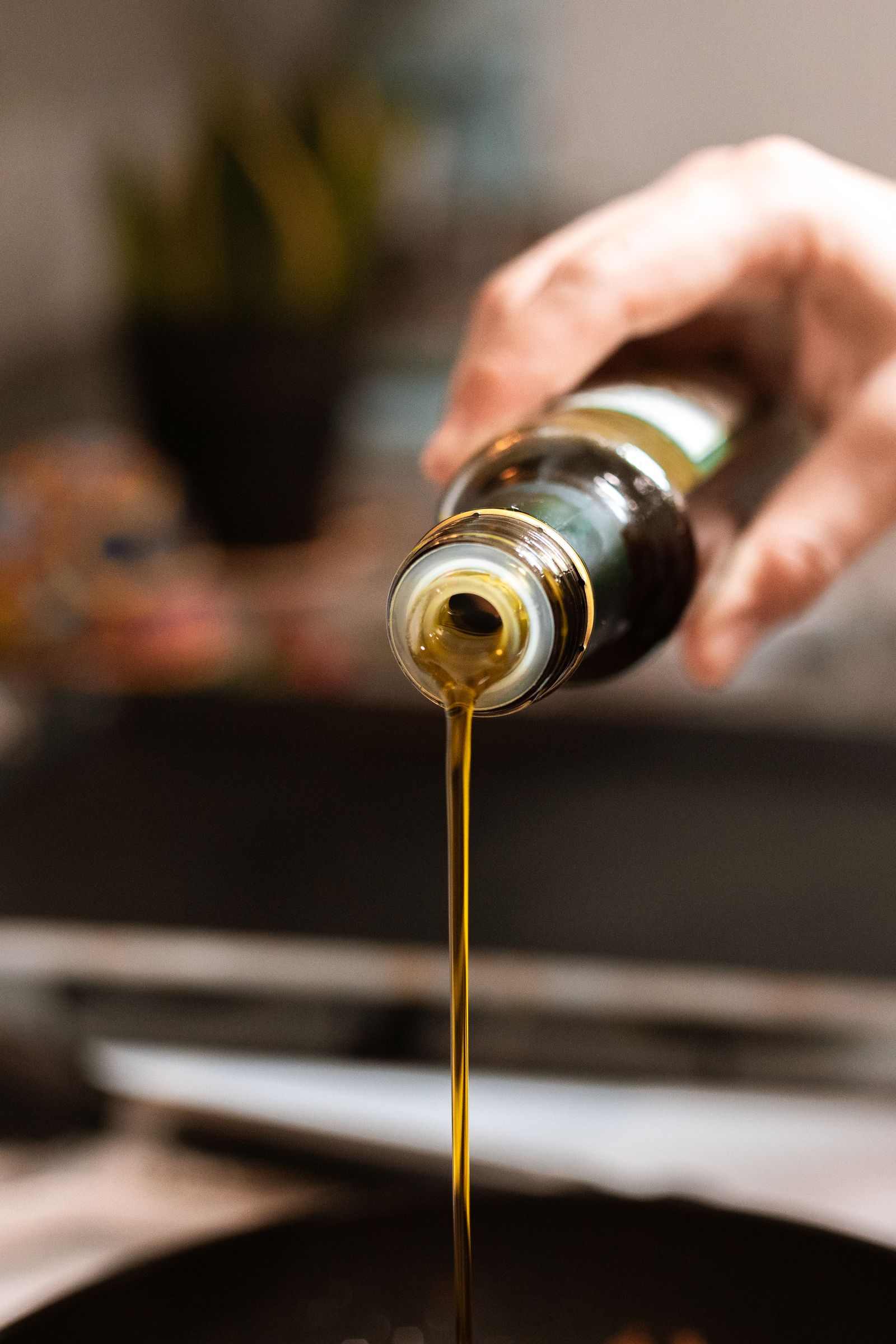 Olive oil being poured from a bottle