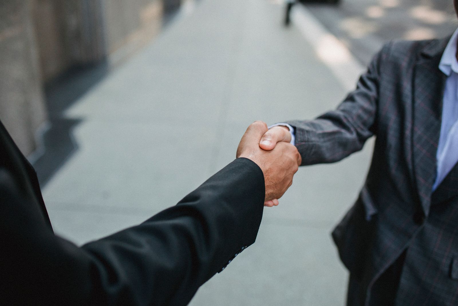 Two professionals shaking hands in agreement