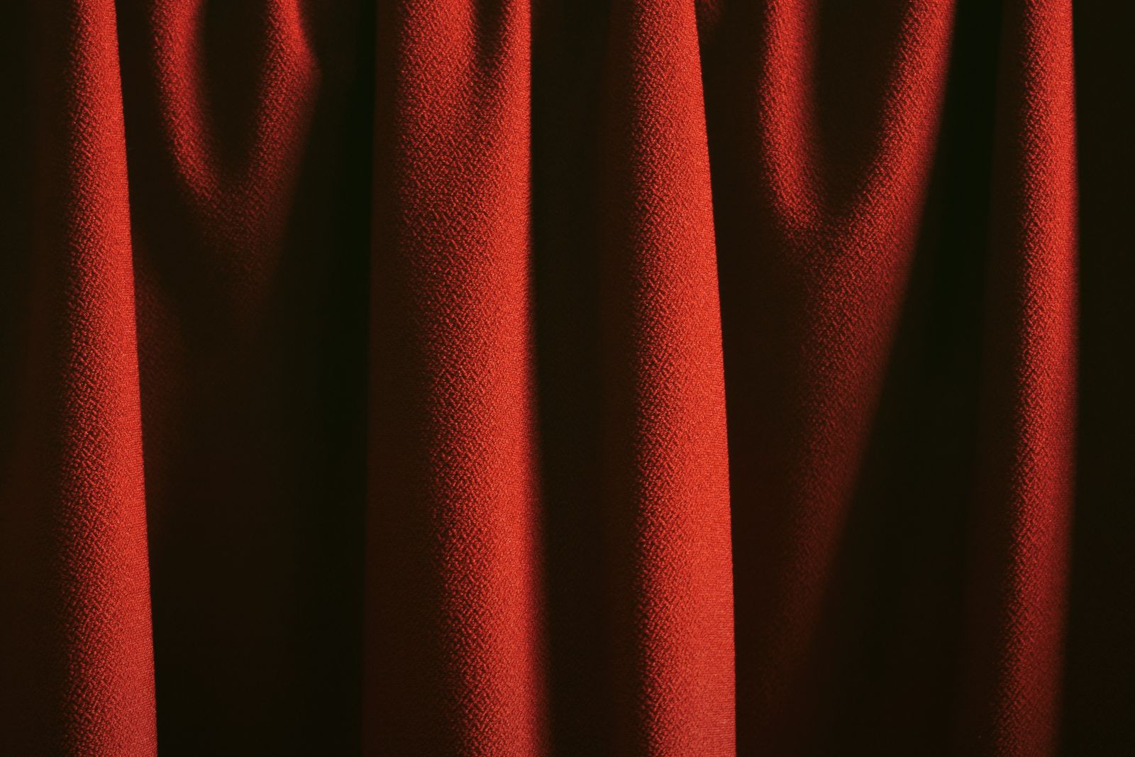 Elegant red curtains in soft lighting