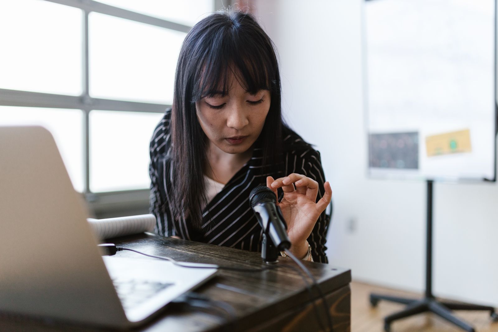 Woman speaking with a microphone during a presentation