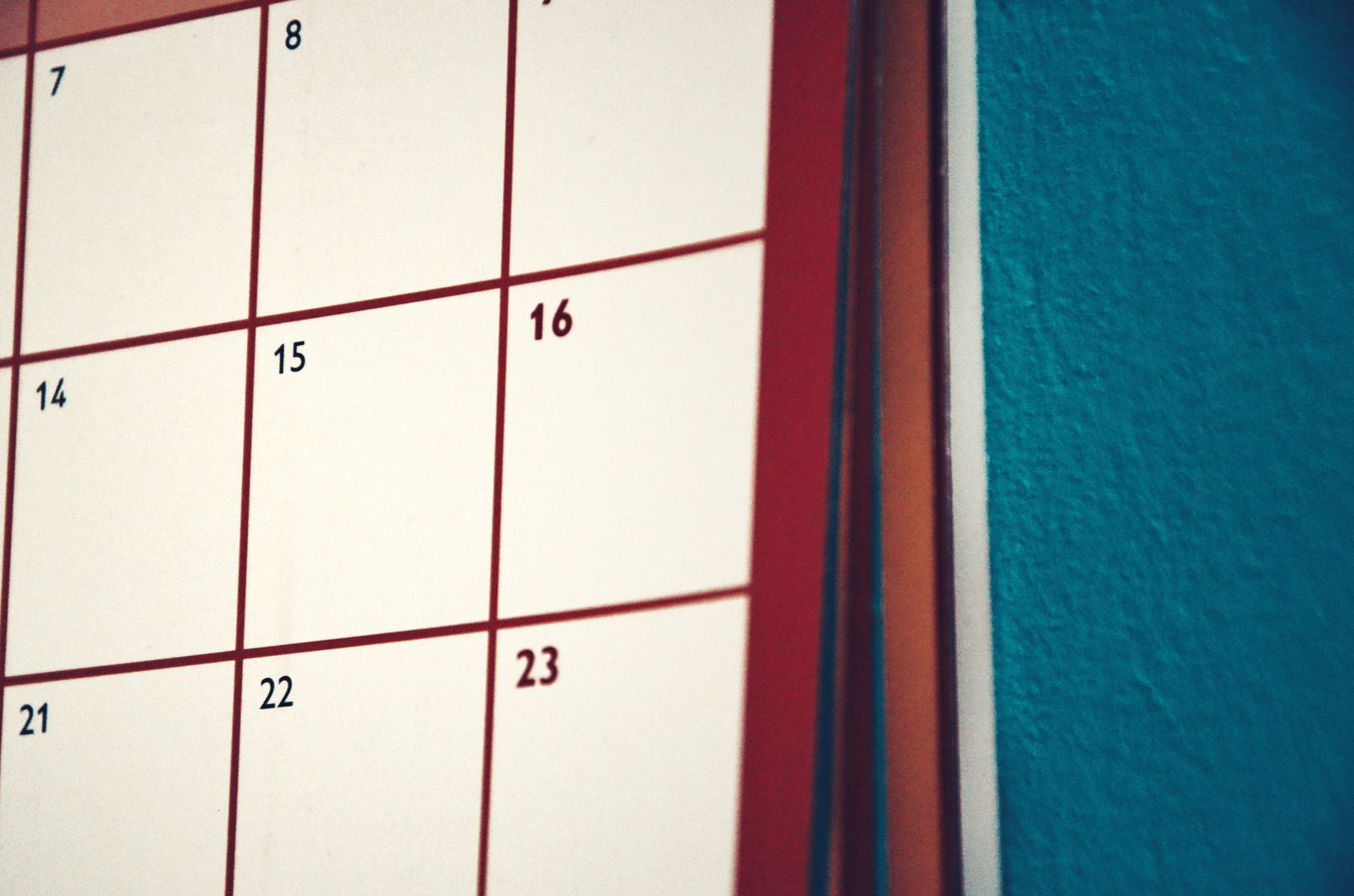 Person planning a schedule on a desk calendar