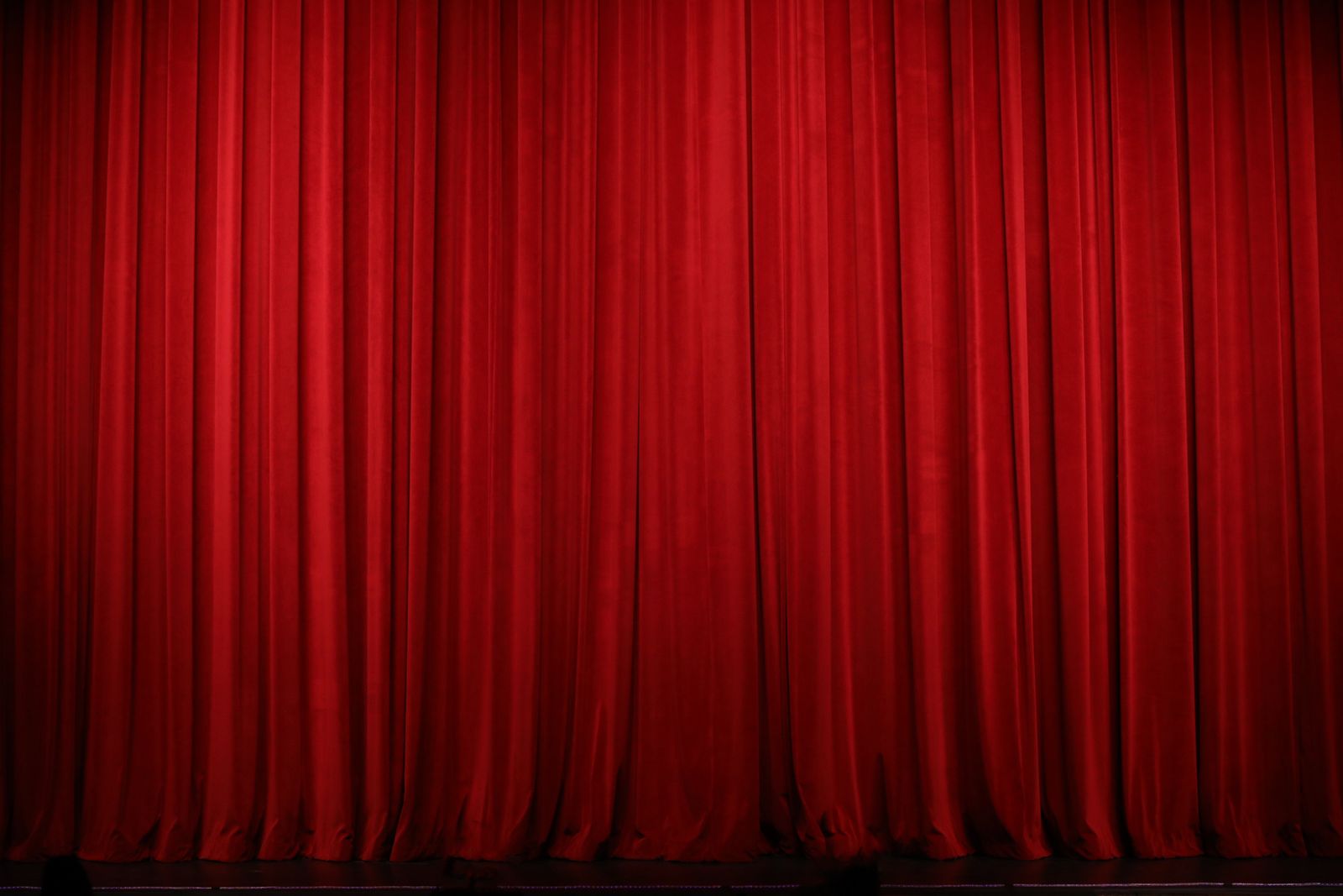Red theater curtain drapes on a stage