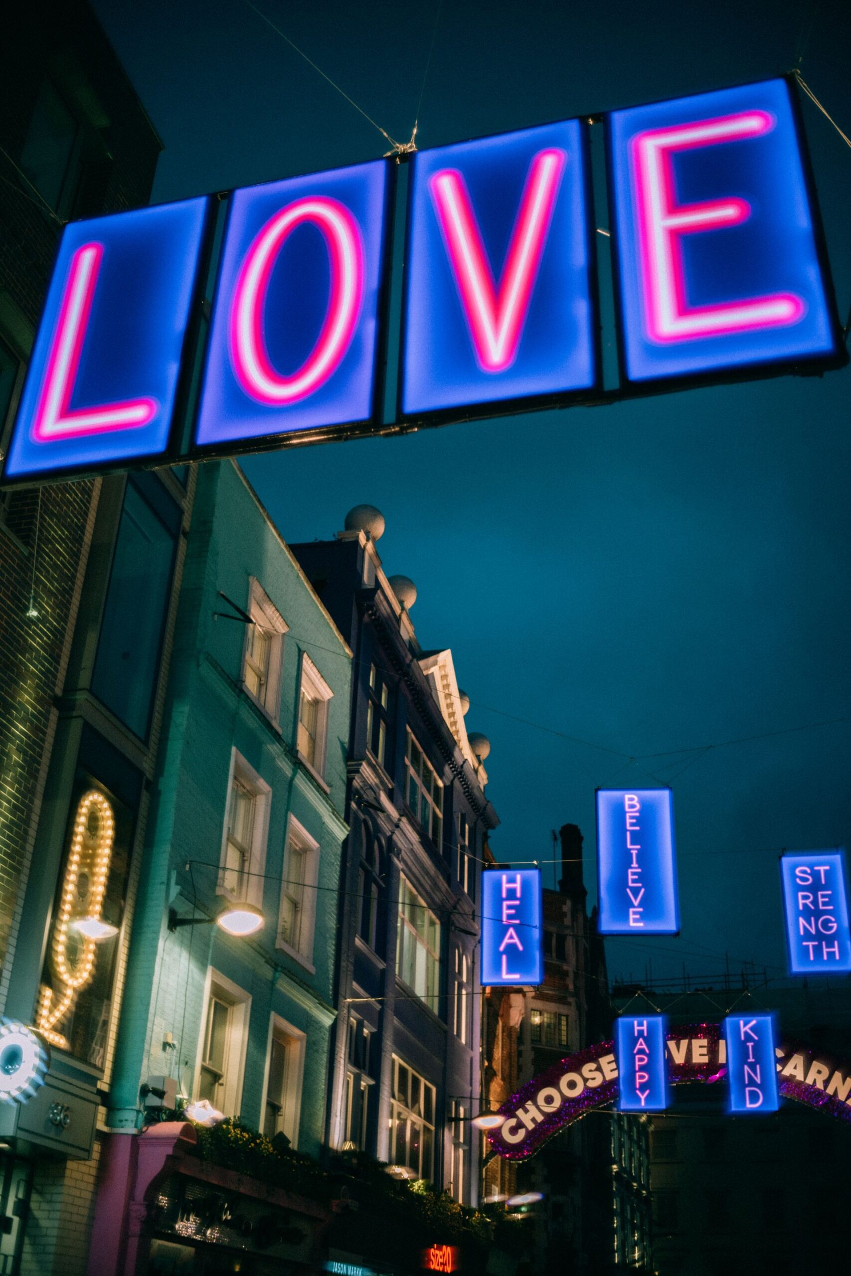 City street at night with neon signs displaying words