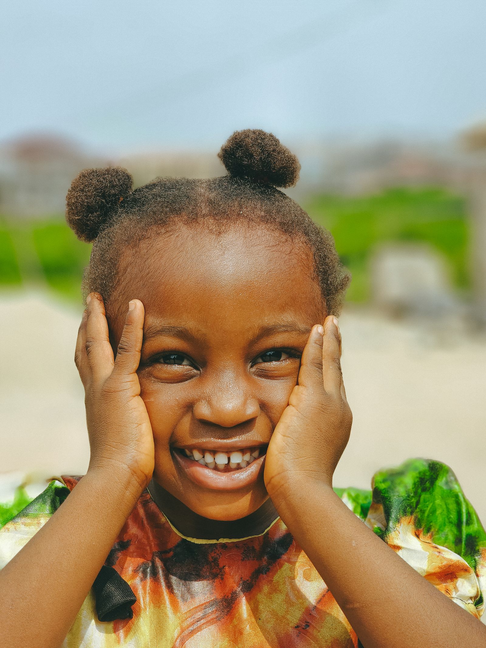 Young girl smiling in a portrait outdoors