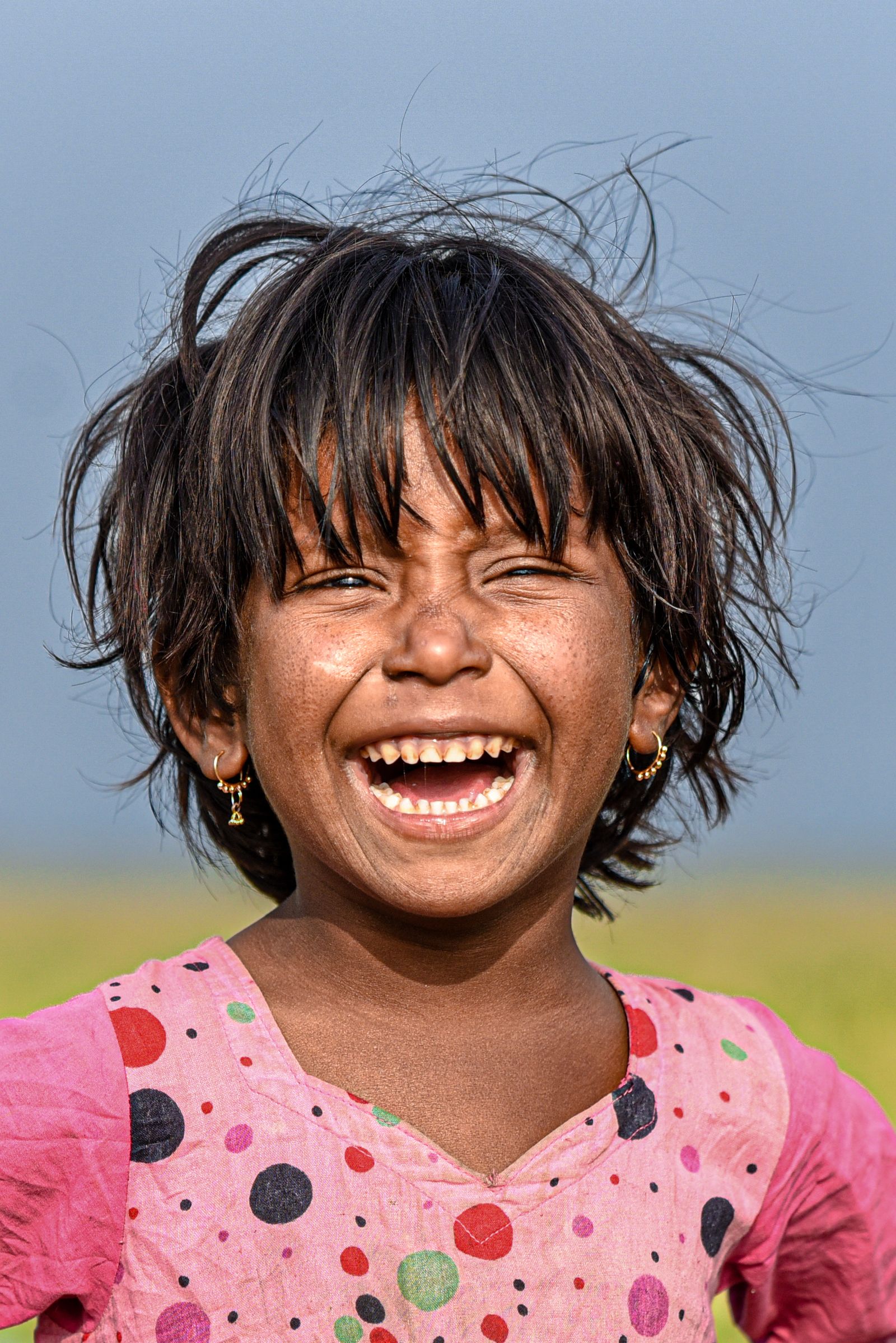Young girl smiling in a portrait outdoors