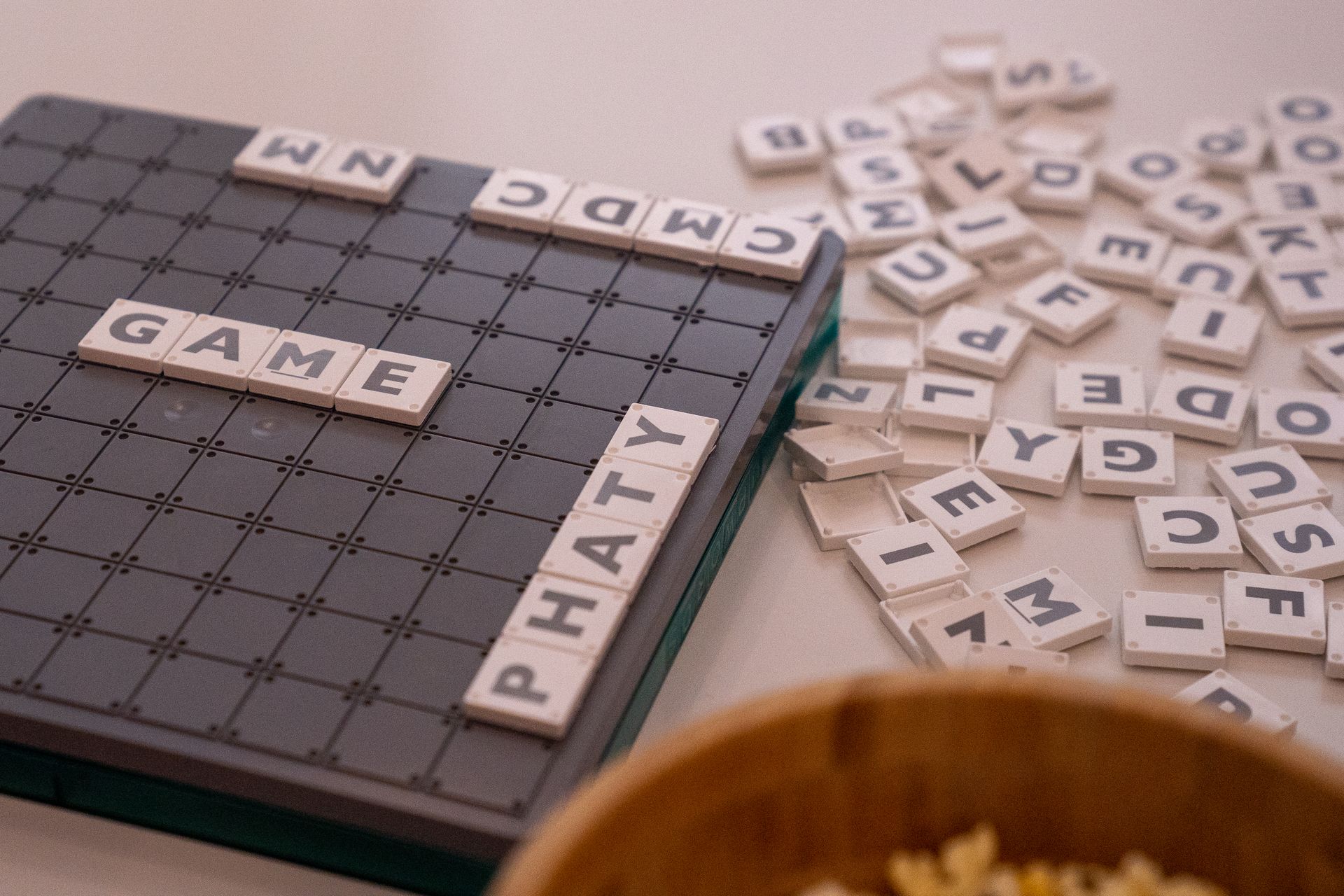 White Scrabble tiles arranged on a game board