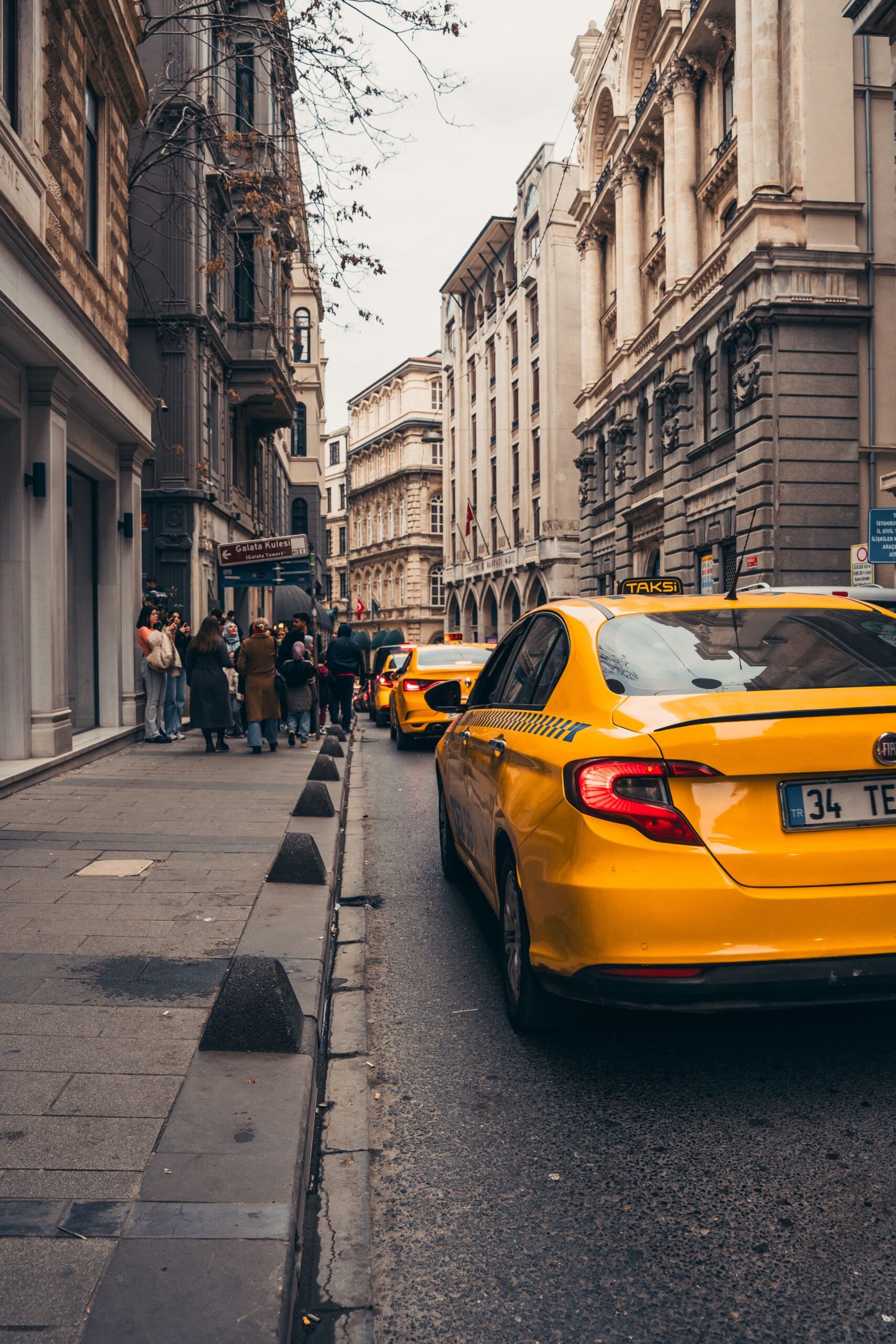 Yellow taxis line a historic street in Istanbul, embodying urban life in Turkey's bustling city.