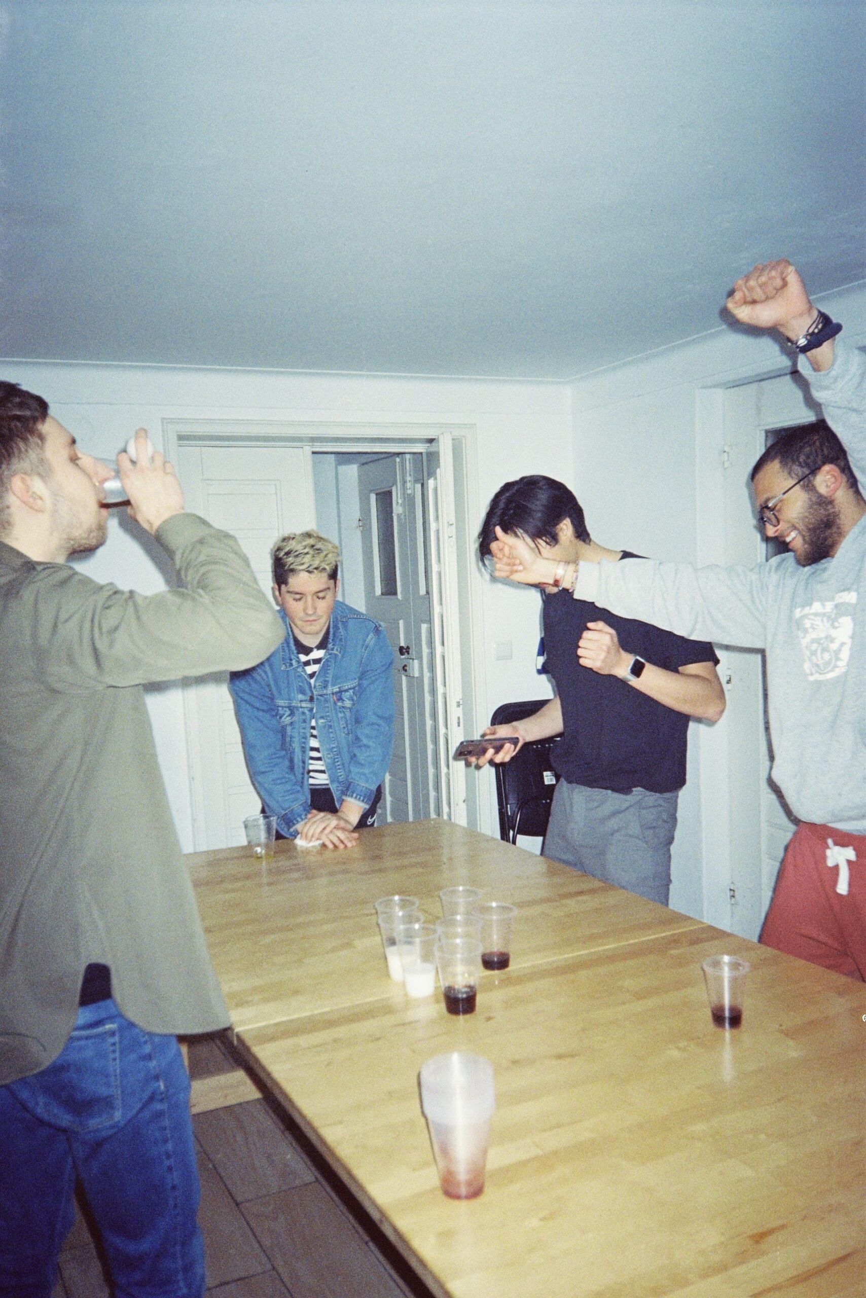 Casual indoor party scene with friends playing games and having fun.
