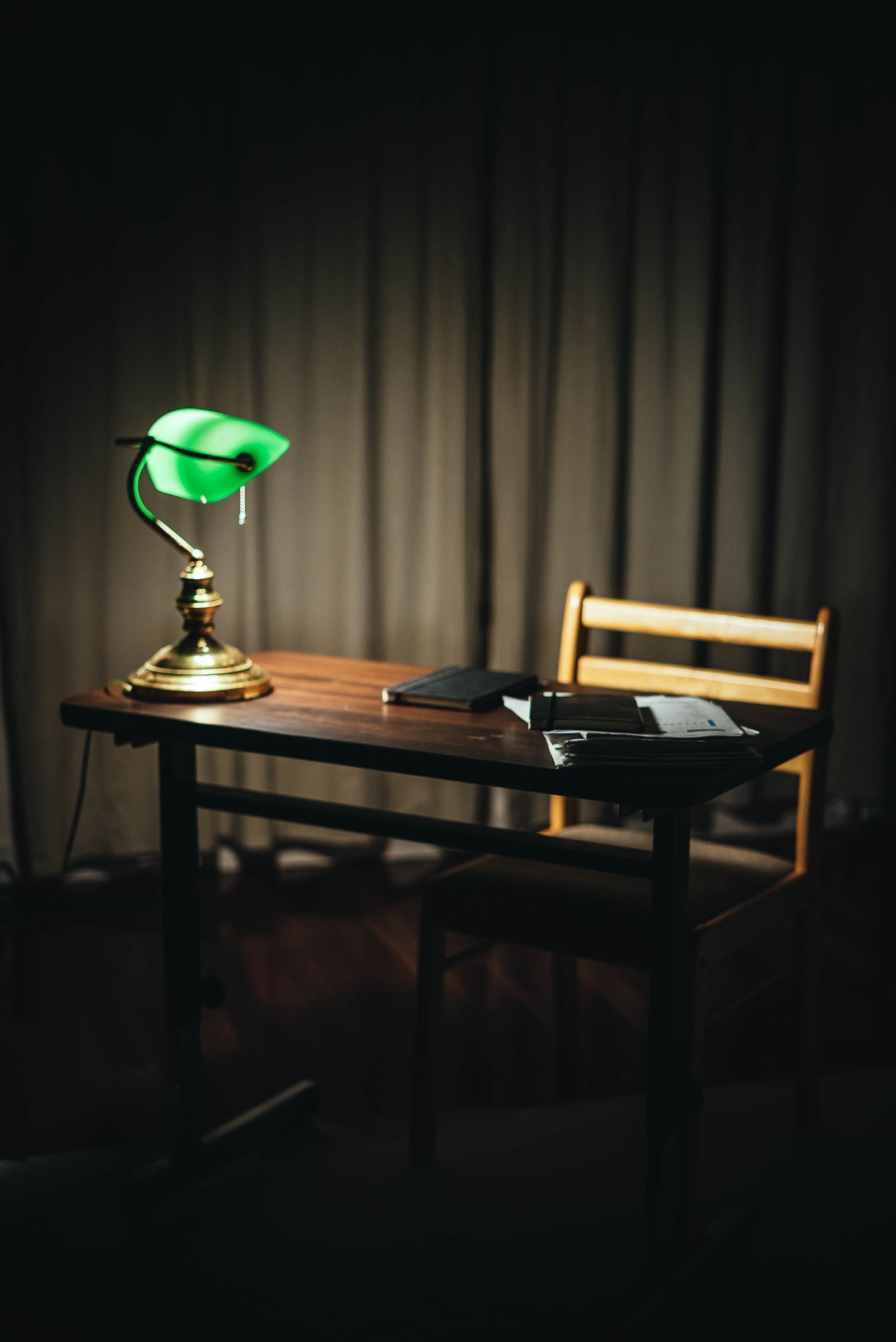 Person studying with books and notes at a wooden desk