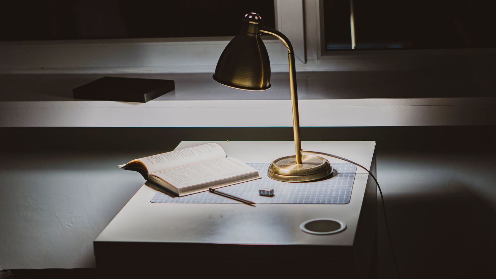 Open book with handwritten notes beside it