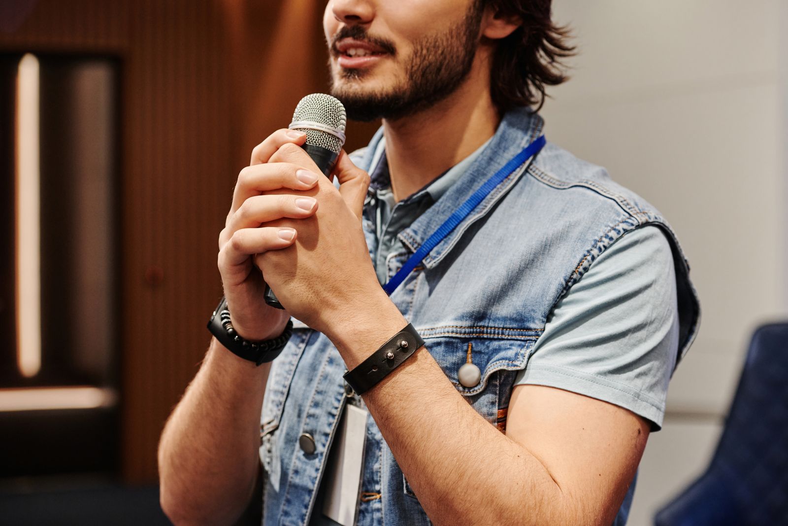 Person speaking into a microphone while practicing pronunciation