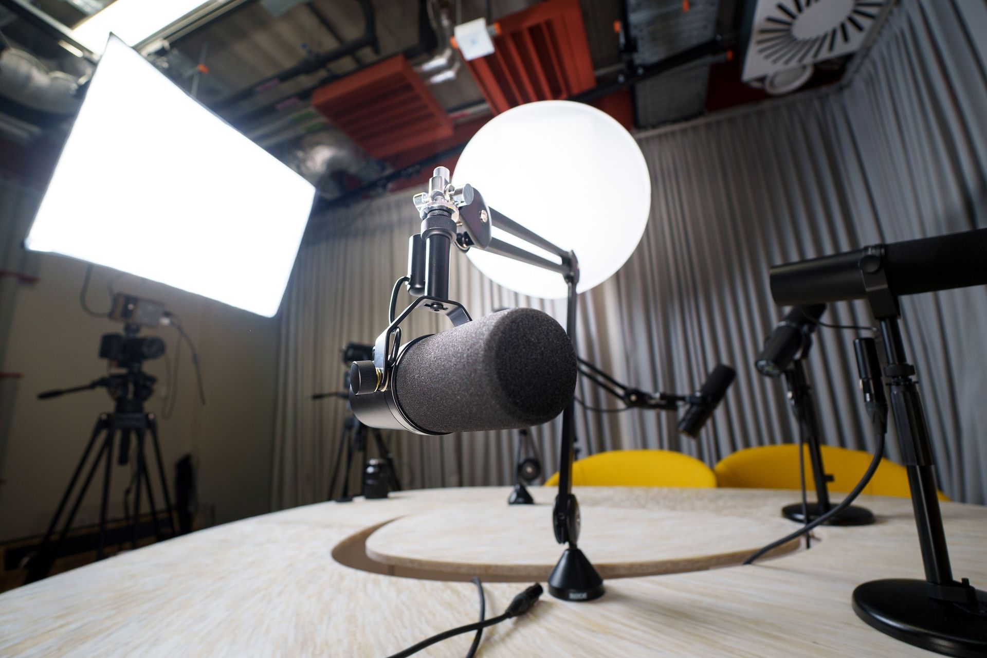 Modern podcast recording studio with microphones and lighting equipment