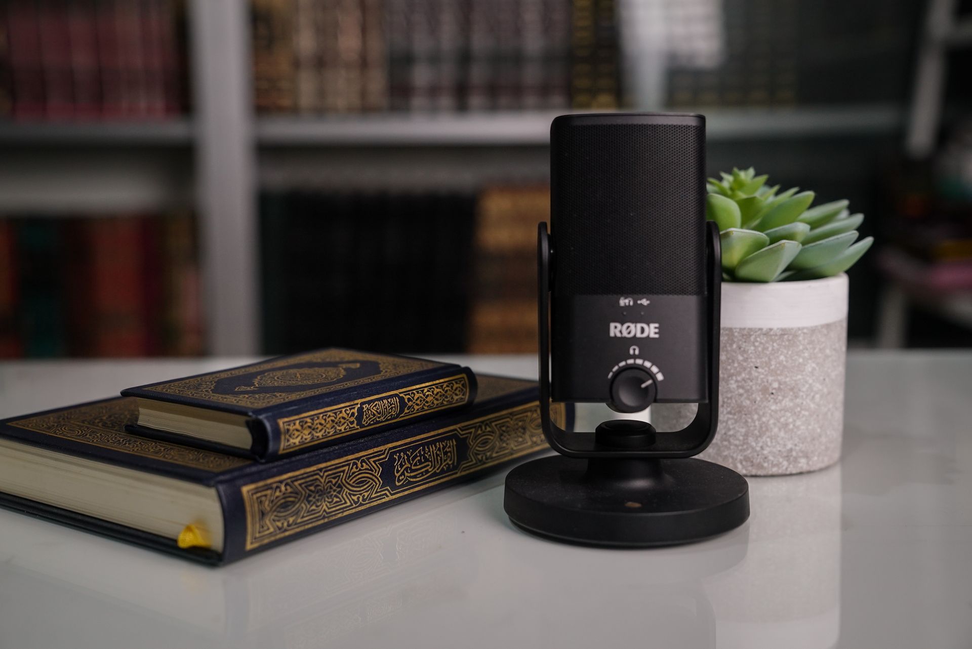 Close-up of books with a microphone on a desk