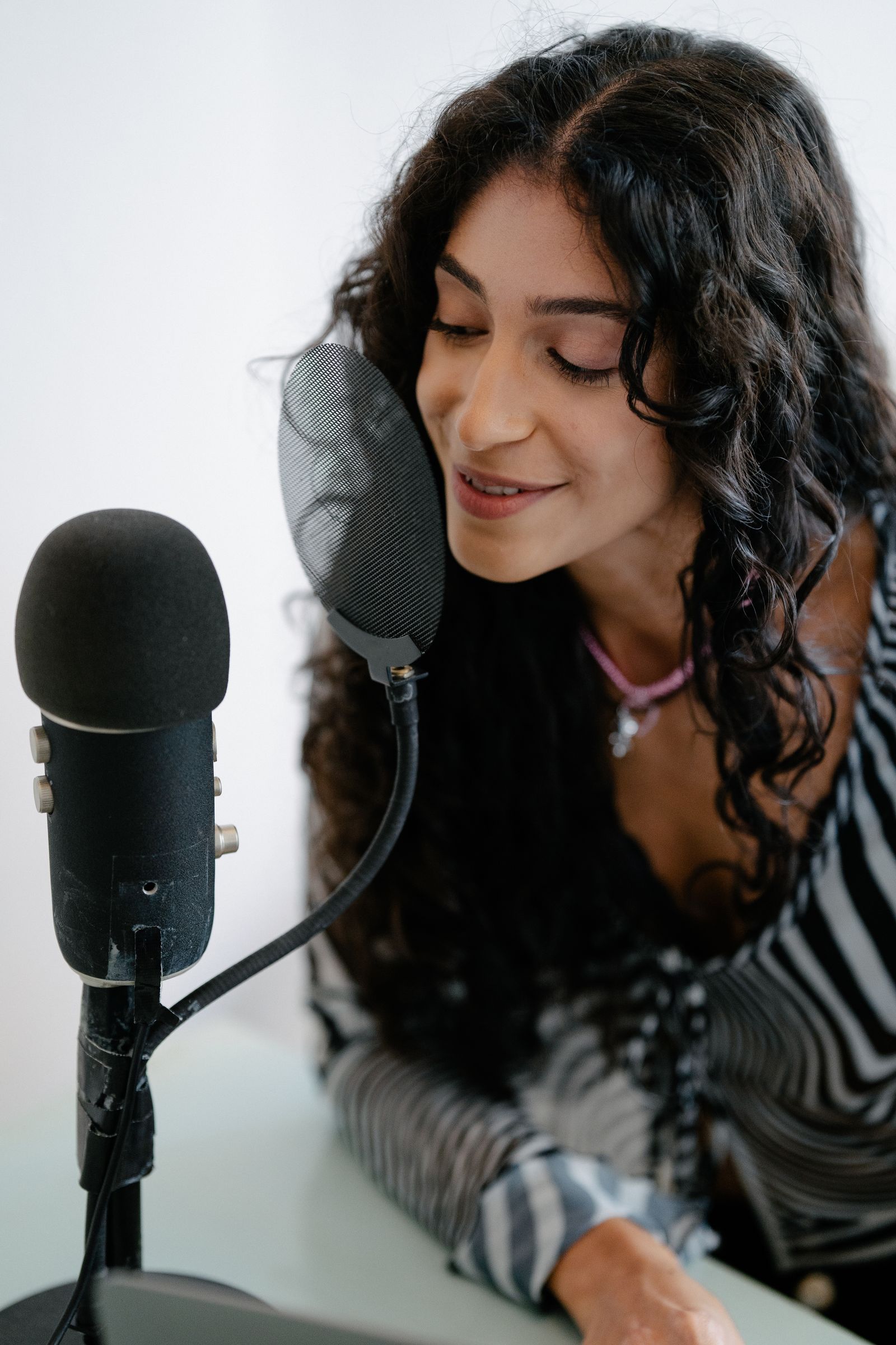 Woman speaking into a studio microphone