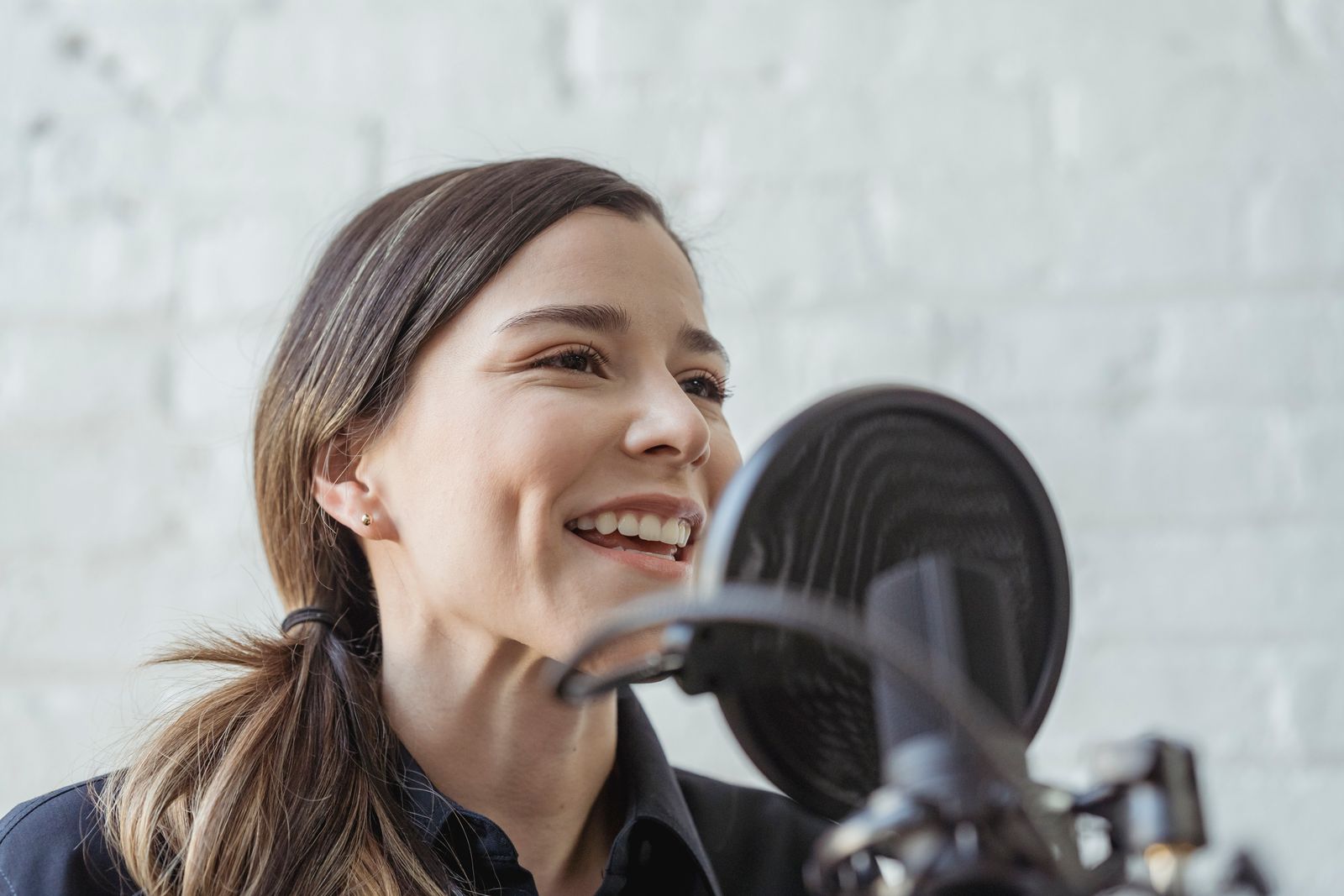 Woman speaking into a studio microphone