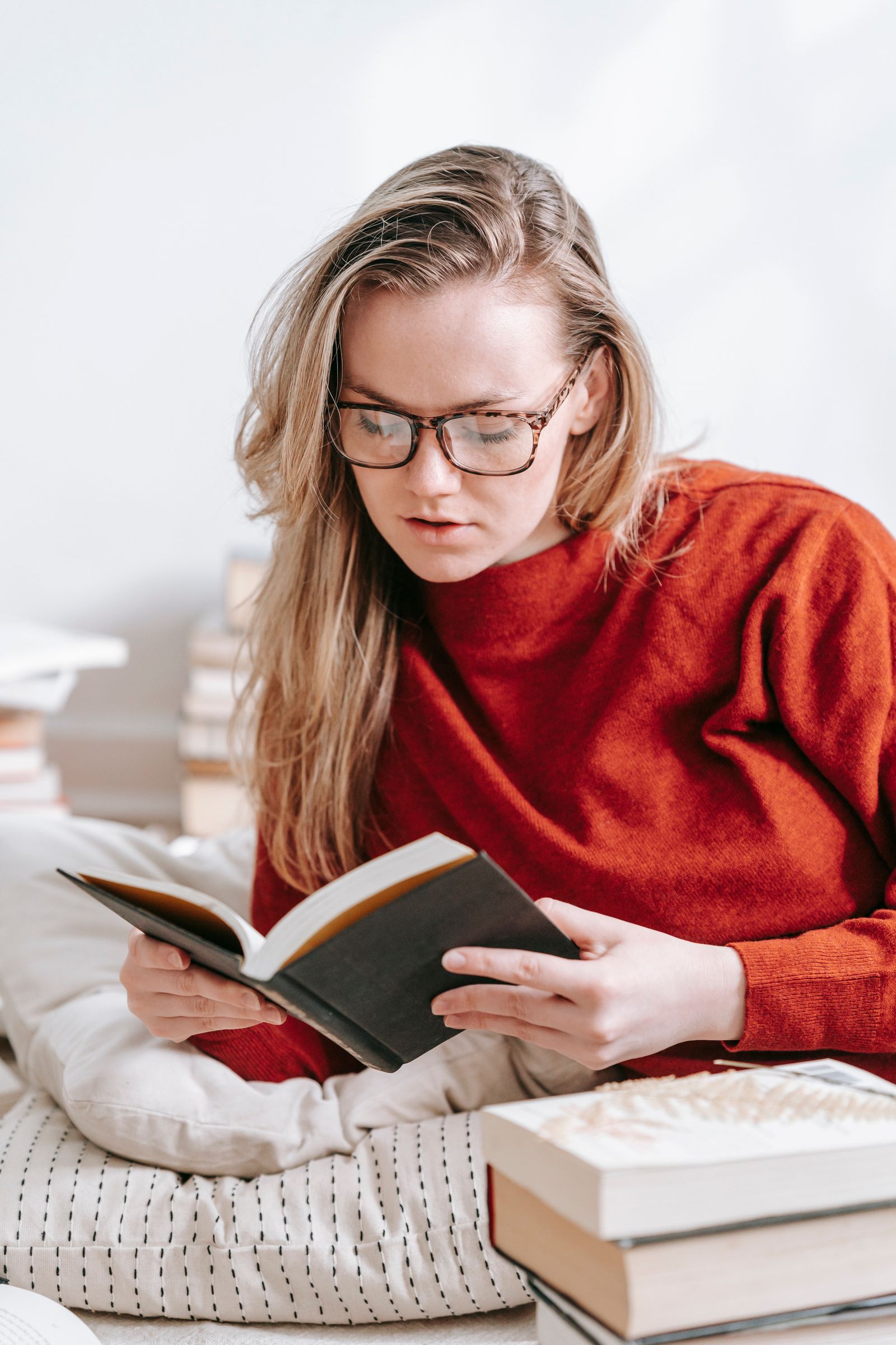 Person reading a book aloud while learning a language