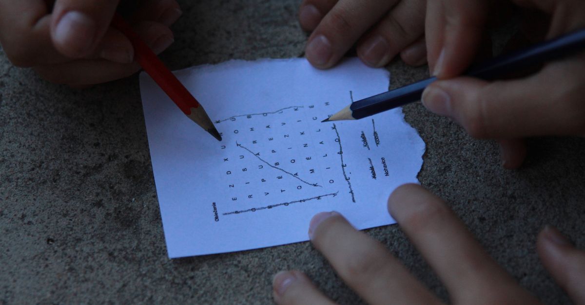 People solving a word puzzle together at a table