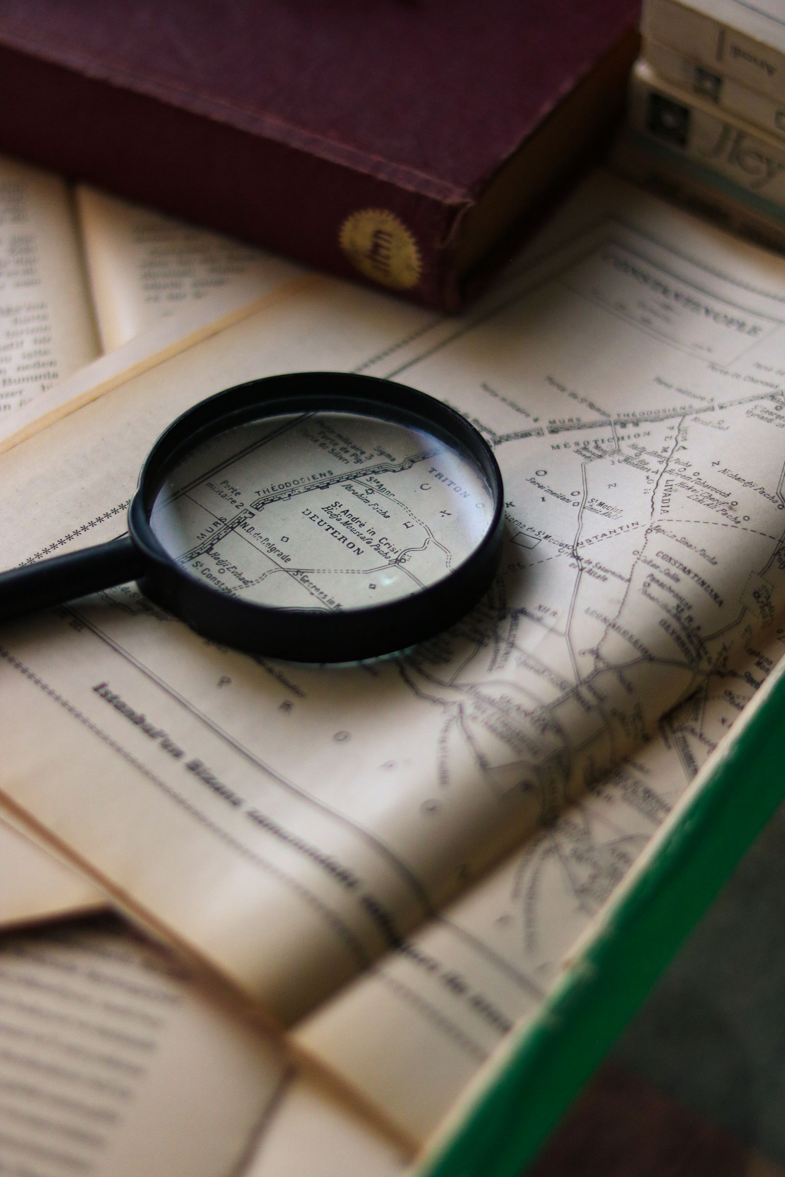 Magnifying glass on a vintage book with a map