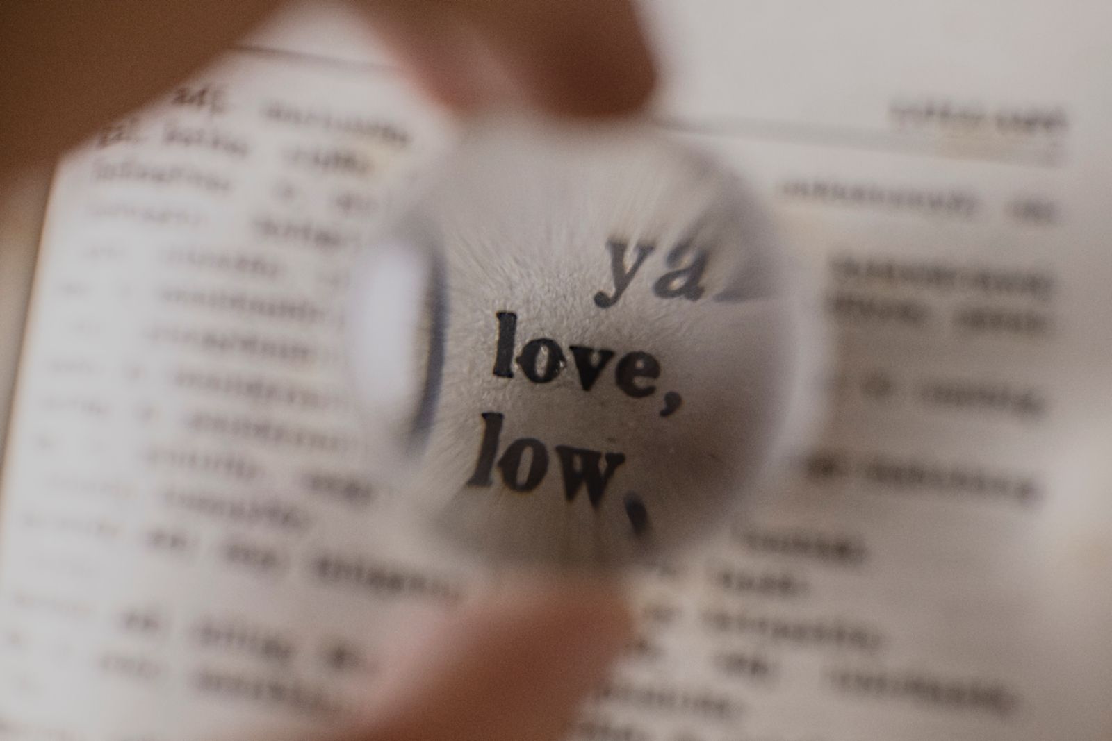 Hand holding a magnifying glass