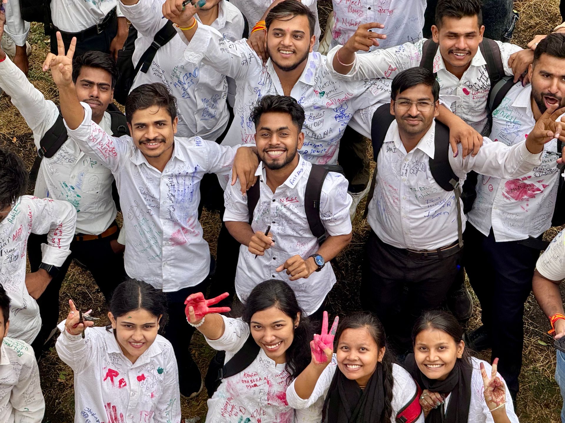 A vibrant group of young friends celebrating outdoors with cheerful expressions