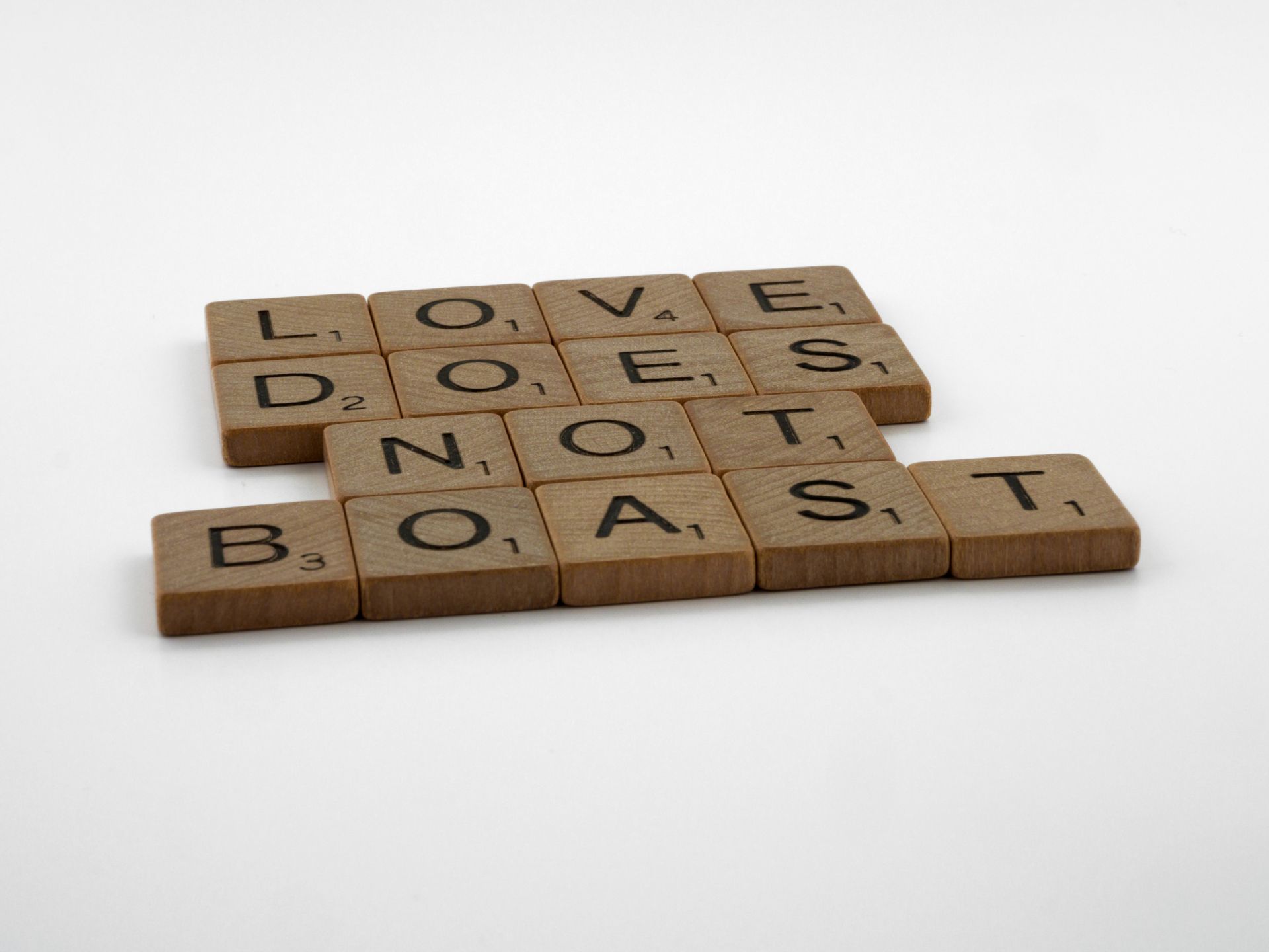 Wooden tiles spelling Love does not give up
