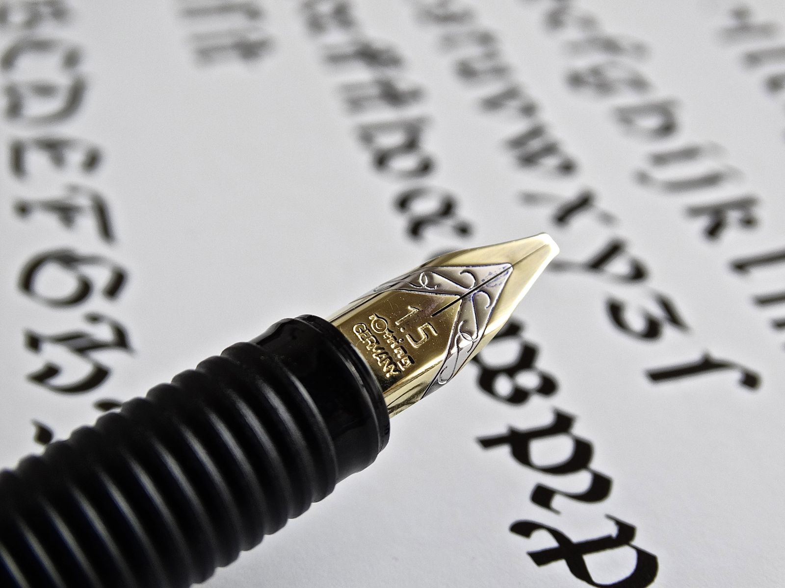 Fountain pen beside handwritten text