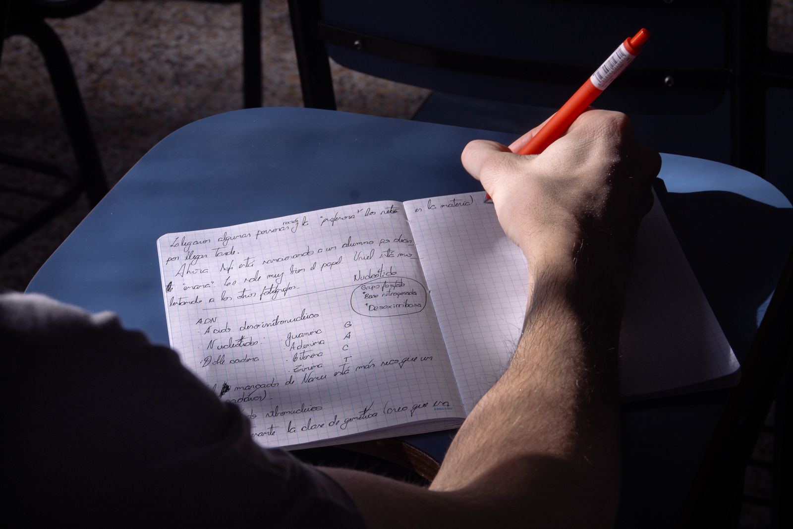 Student taking notes in a classroom