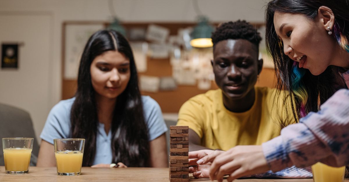 Hands playing a word board game