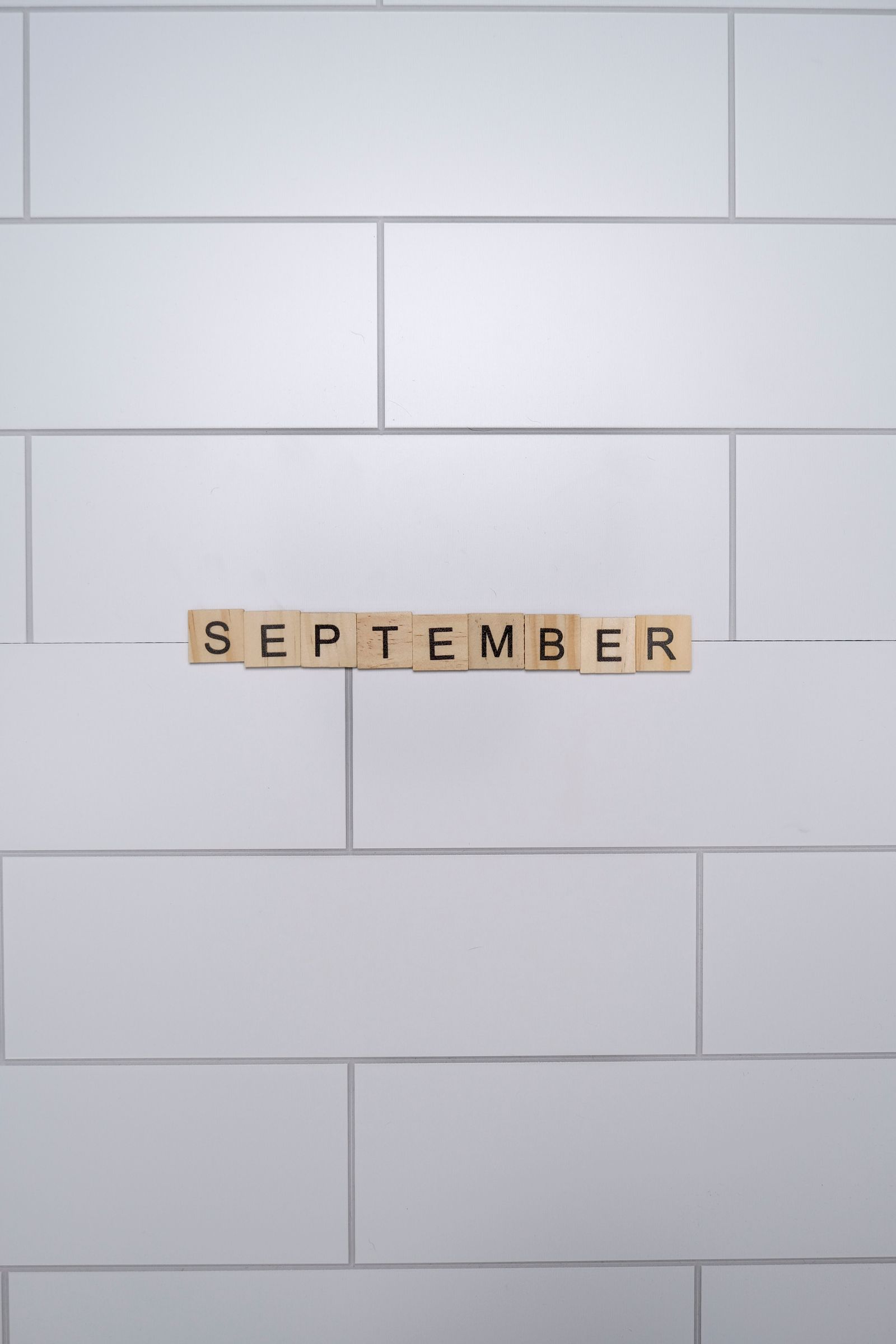 Scrabble tiles spelling a month name