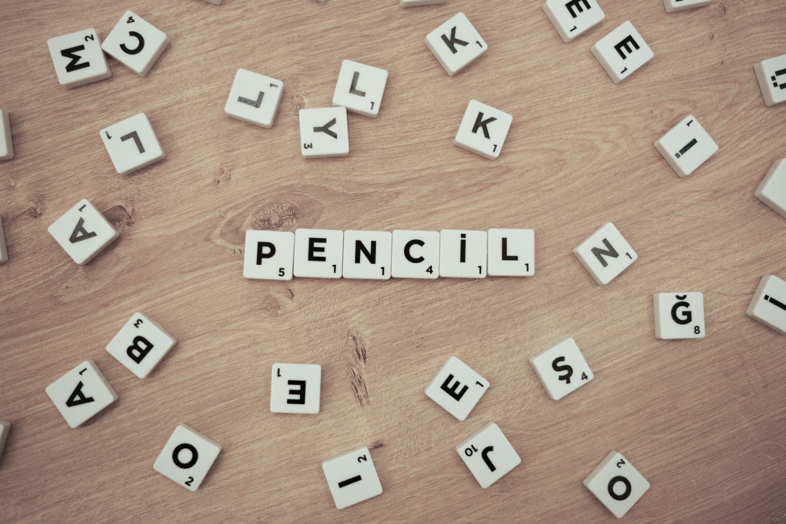 Scrabble tiles forming a short word on wood