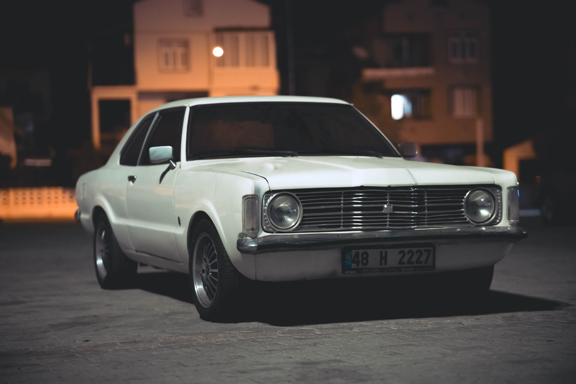 Vintage white Ford Taunus classic car at night