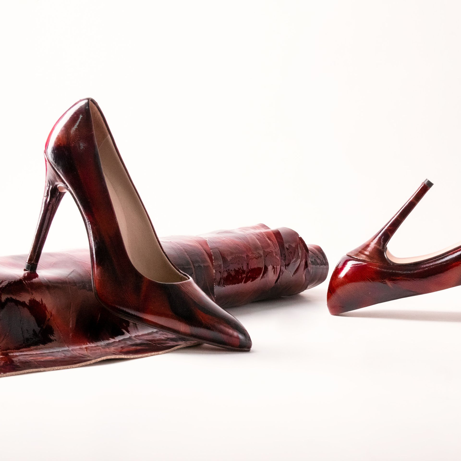 Stylish red high heels on a white background