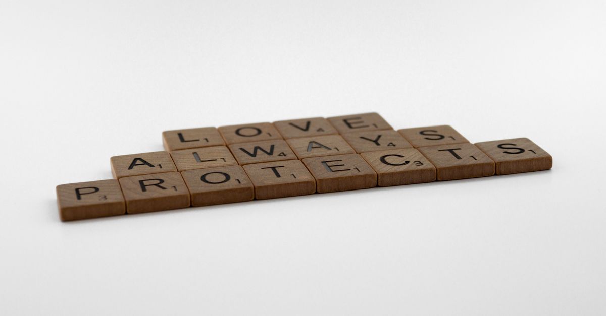 Brown wooden Scrabble pieces on a white surface