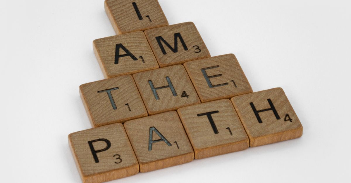 Close-up of Scrabble tiles on a white surface