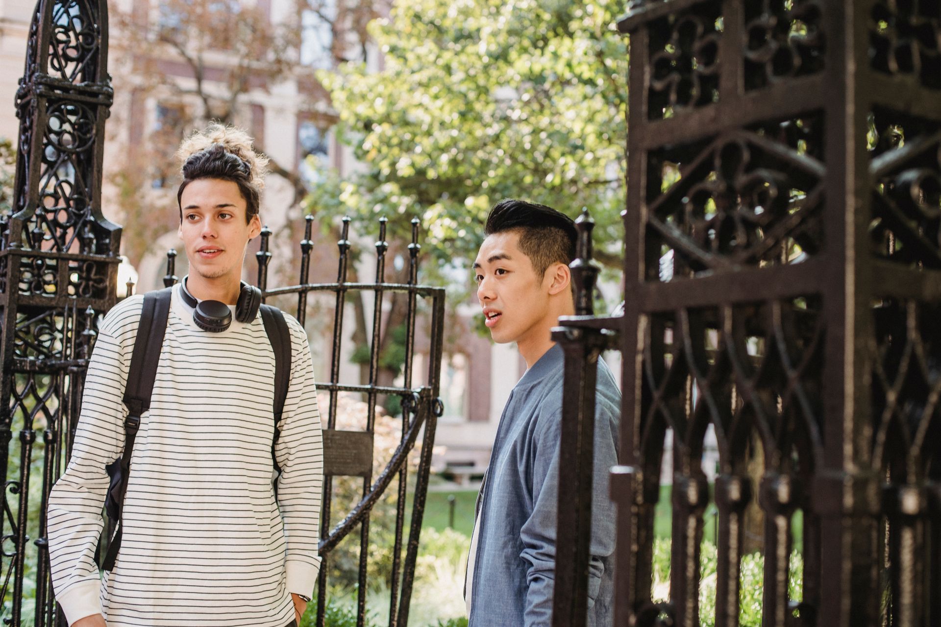 Students standing near the gates of a university building