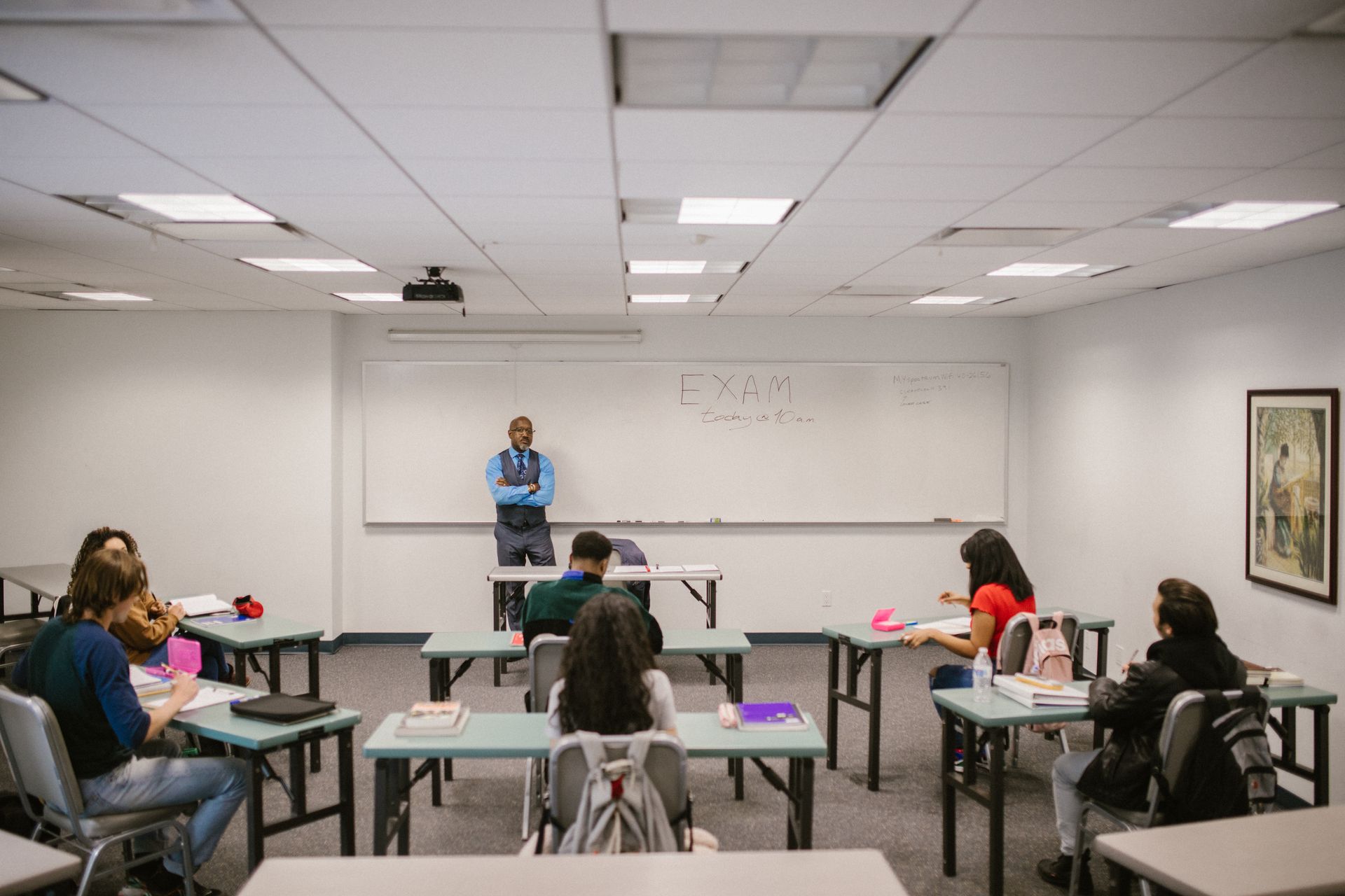 Teacher proctoring students during an examination