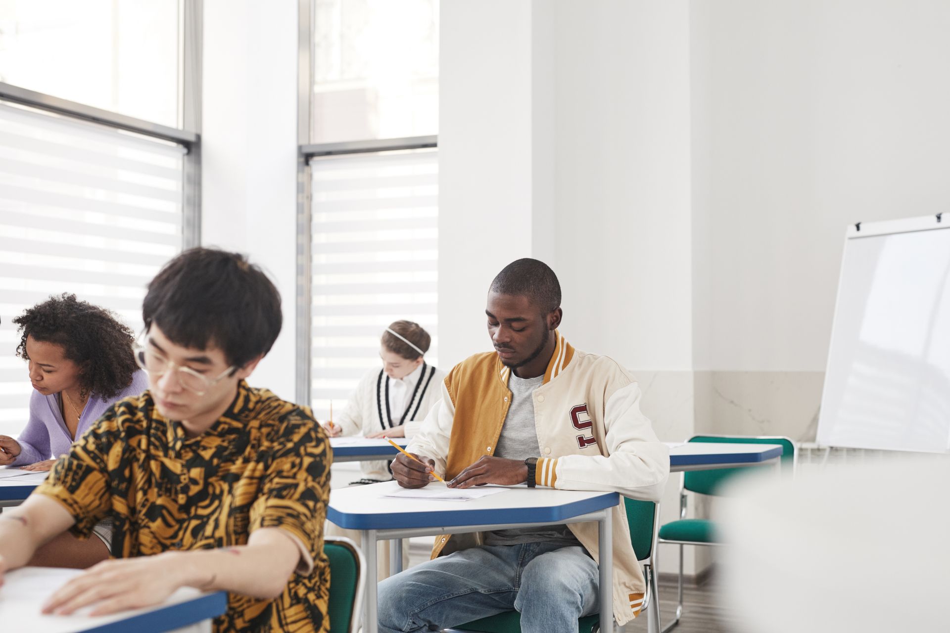 Students sitting in a classroom taking an exam